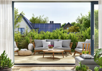 View of house with solar panels from garden patio.