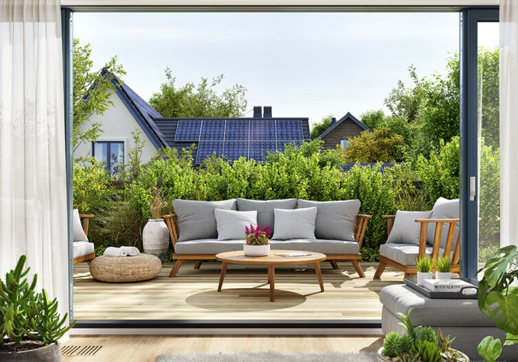 View of house with solar panels from garden patio.