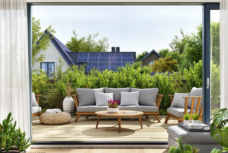 View of house with solar panels from garden patio.