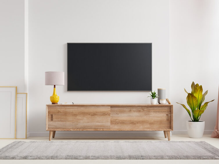 TV mounted to the wall above sideboard in living room