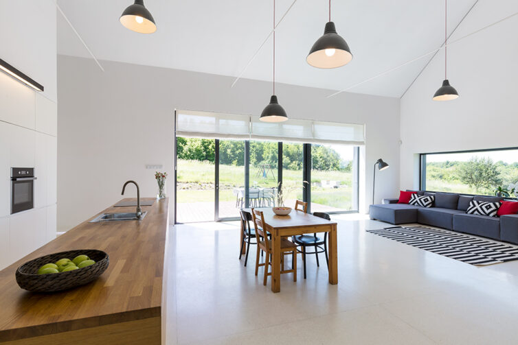 Open plan kitchen lounge area leading to gaden via large glass doors