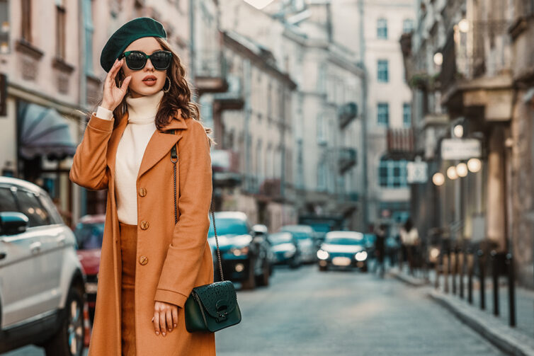 Women with fashionable coat, sunglasses and beret