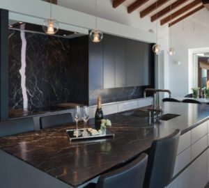 Modern stylish dark kitchen with black marble countertops
