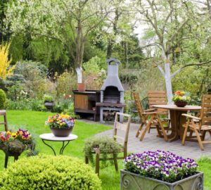 Garden with wooden furniture and pizza oven