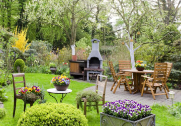 Garden with wooden furniture and pizza oven