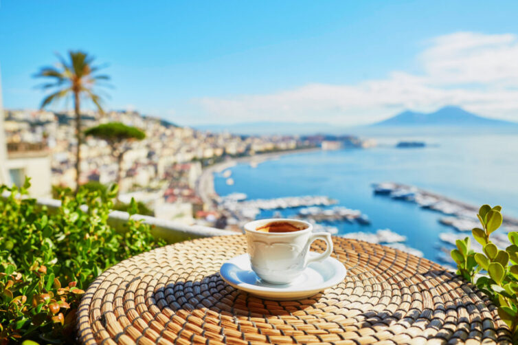 Cup of fresh espresso coffee in a cafe with view on Vesuvius mount in Naples, Campania, Southern Italy