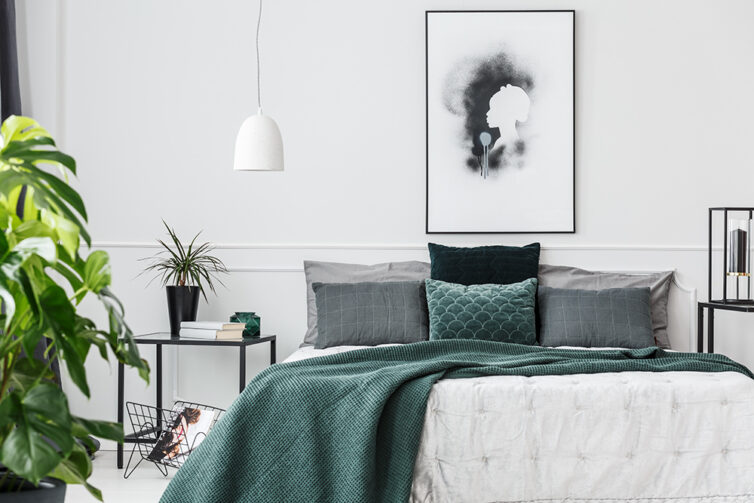 Large bedroom with white, black, grey and green colouring.