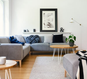 Grey corner Sofa in white room and wooden floor