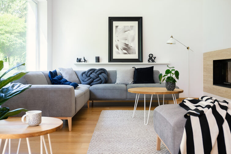 Grey corner Sofa in white room and wooden floor