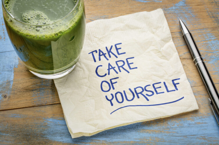 Take care of yourself written on napkin next to green juice