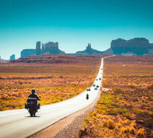 Biker on Monument Valley road at sunset, USA