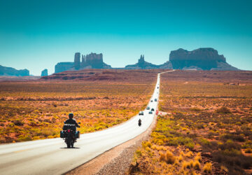 Biker on Monument Valley road at sunset, USA