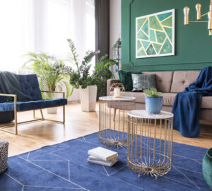 Green and blue tropical living room with plants and brass