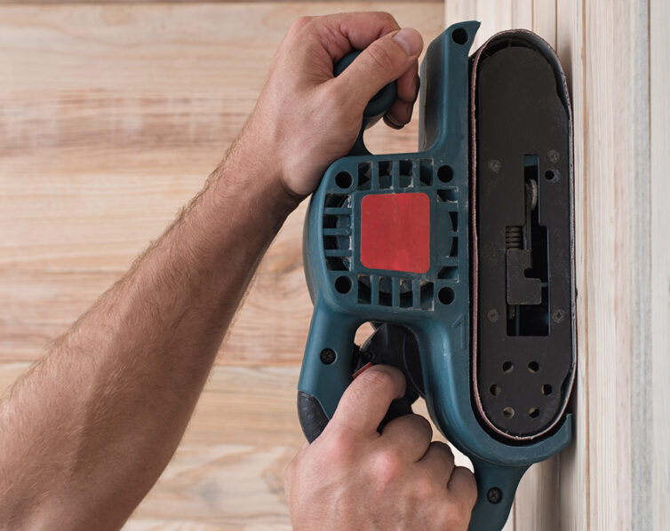 Sanding wood with electric sander