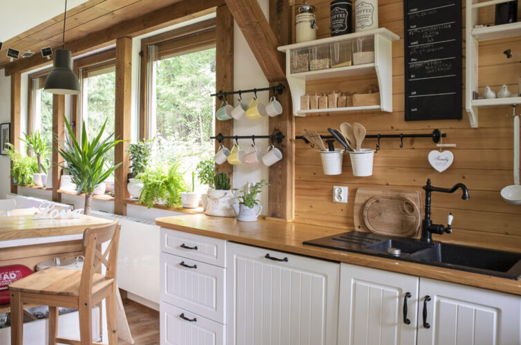 Country kitchen with white cupboards and wooden worksurfaces