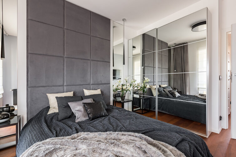 Grey and white modern bedroom with glass wadrobe