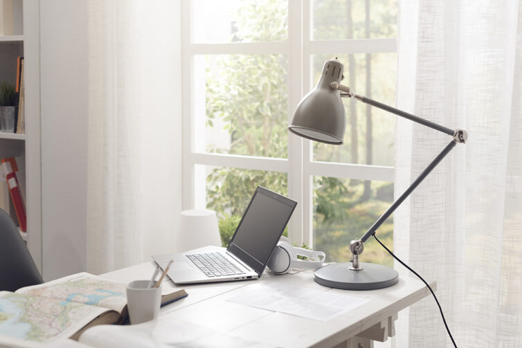 White home office with french doors, desk, lamp and laptop