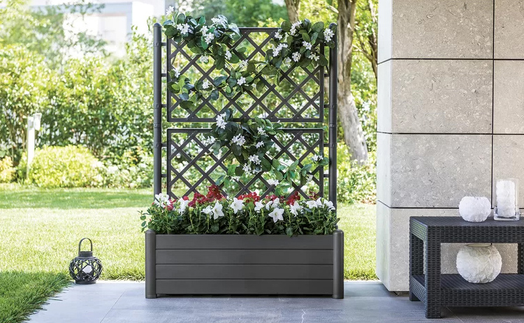 Large planter with decorative trellis.