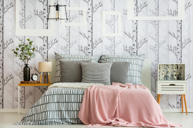 Bedroom decorated with pillows, sheets and wallpaper