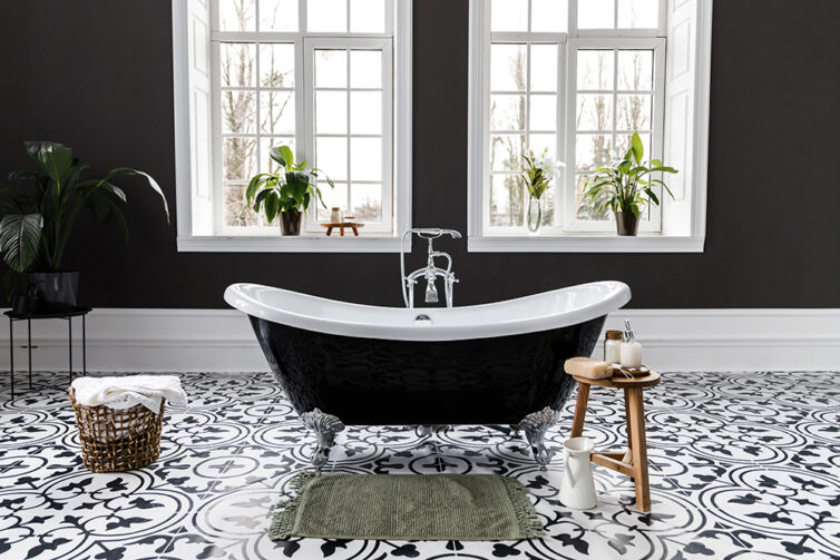 Bathroom with black painted walls and black roll top bath