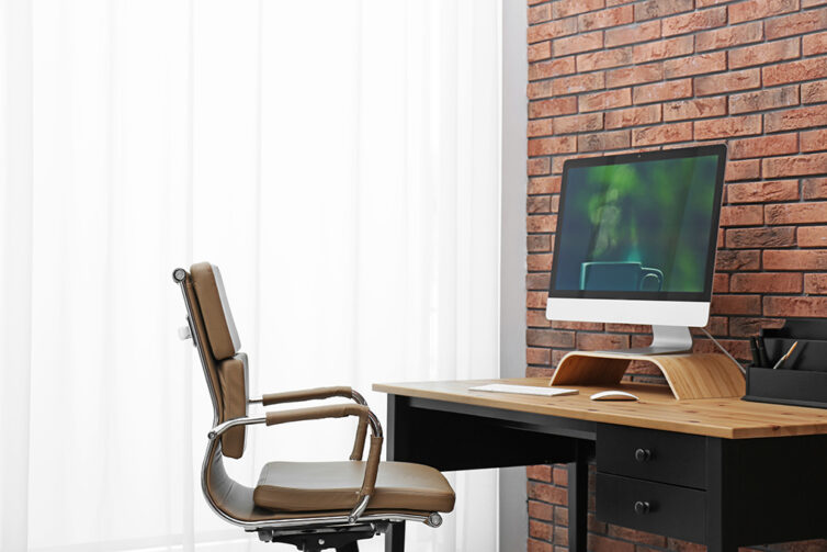 Home office with office chair, desk and apple computer