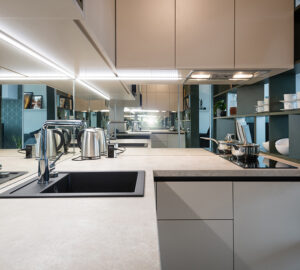 Small white kitchen with glass splashback