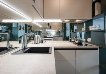 Small white kitchen with glass splashback