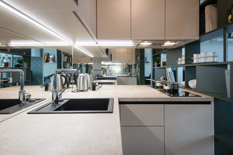 Small white kitchen with glass splashback