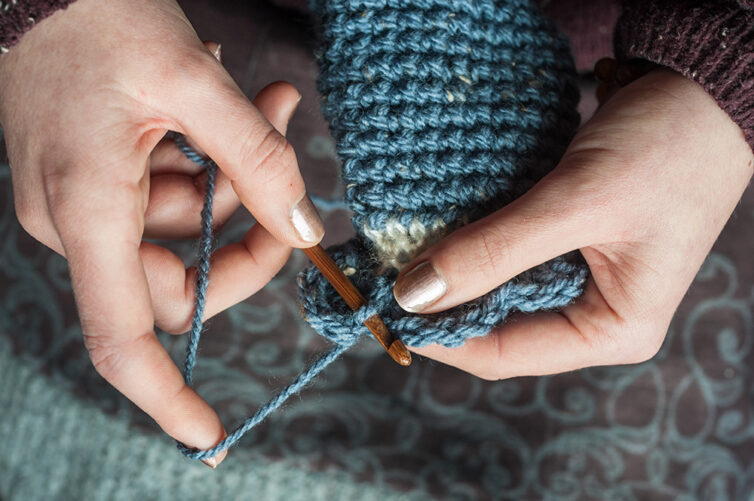 woman's hands crocheting