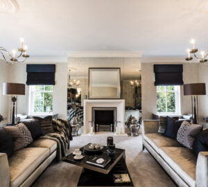 Stylish living room with luxuary silver sofas. Fireplace focal point