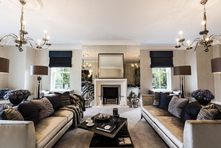 Stylish living room with luxuary silver sofas. Fireplace focal point
