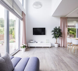 Contempory minimalist living room and open planed kitchen with grey laminate flooring