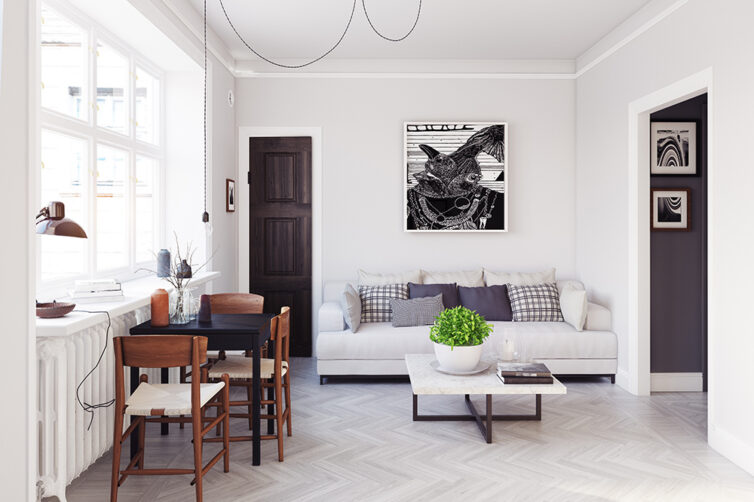 Small apartment with sofa and small dining table. Flooring covered in grey herringbone laminate