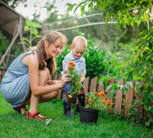 Women and child planting plants in the garden