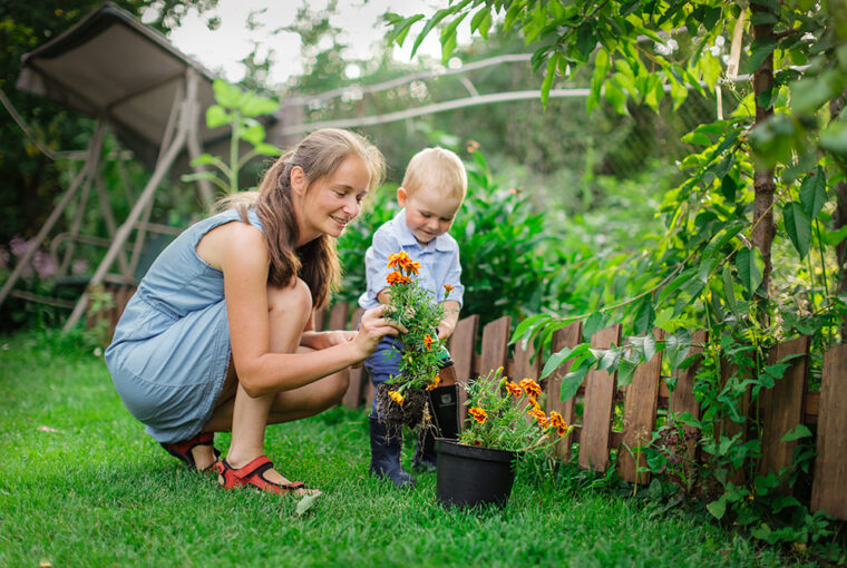 Women and child planting plants in the garden