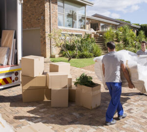 Removal company delivering sofa and boxes to new home with box van