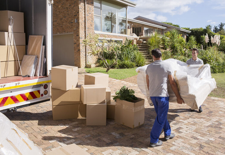 Removal company delivering sofa and boxes to new home with box van