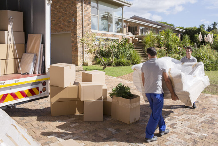 Removal company delivering sofa and boxes to new home with box van