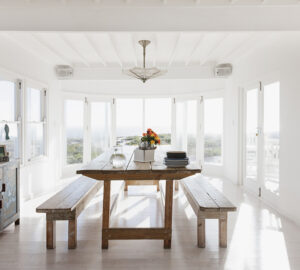 Dining room with wooden dining table and bench chairs.