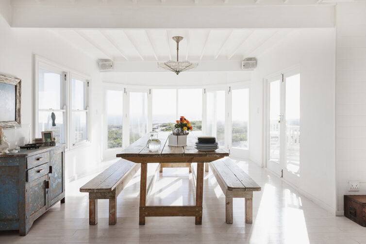 Dining room with wooden dining table and bench chairs.