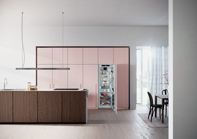 Modern pink kitchen units with intergrated Liebherr fridge