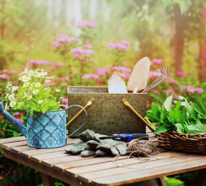 Garden table with watering can, gardening gloves and gardening tools