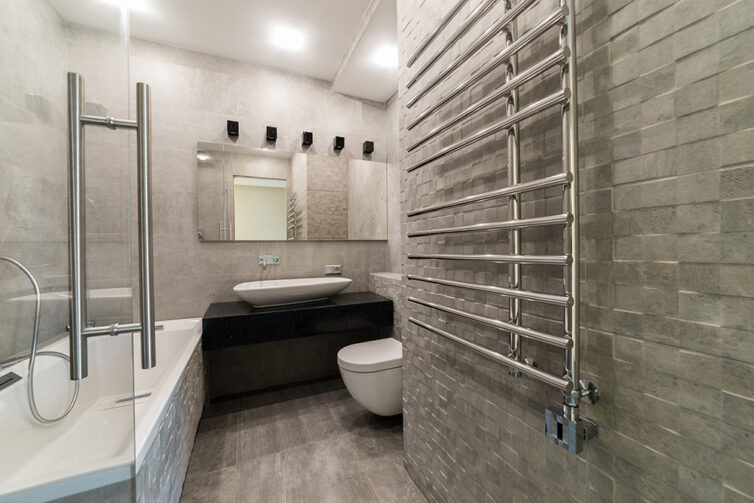 Modern bathroom with metal wall fitted towel heater