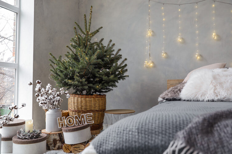 Christmas fairy lights and christmas tree in bedroom