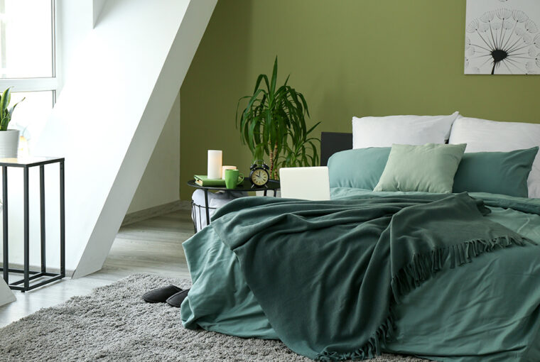 Bedroom with green walls, green bedding and green blanket