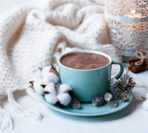 Hot chocolate, cosy blanket and candle