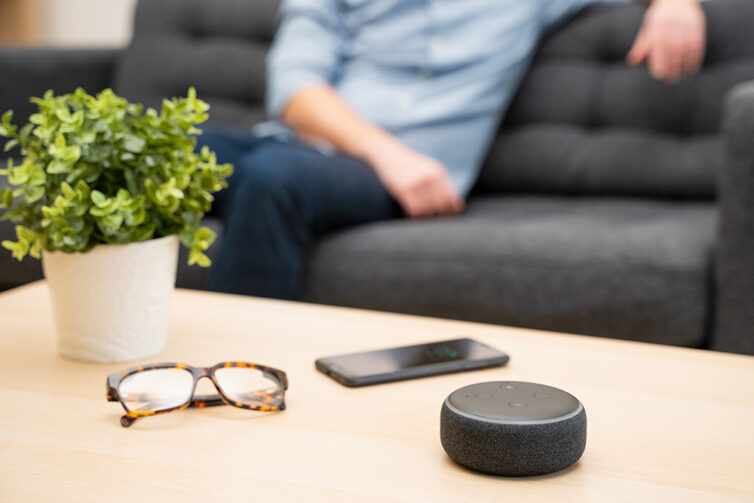 Table with glasses, smart phone and wireless wifi speaker