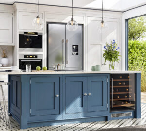 Blue and white kitchen cabinets in with built in cooker, American style fridge freezer and wine cooler cabinet