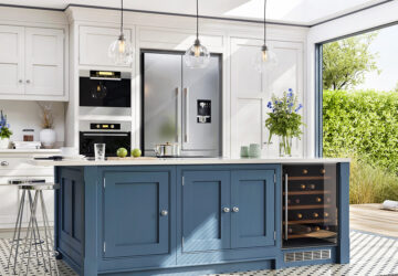 Blue and white kitchen cabinets in with built in cooker, American style fridge freezer and wine cooler cabinet