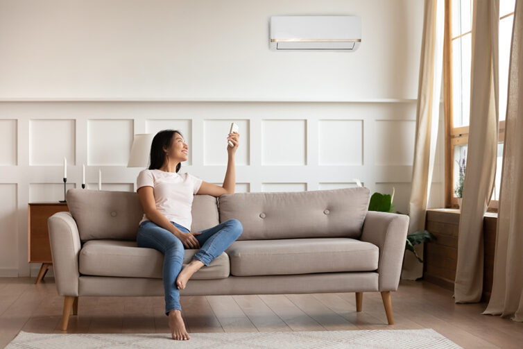 Large livingroom with grey sofa and air conditioning unit